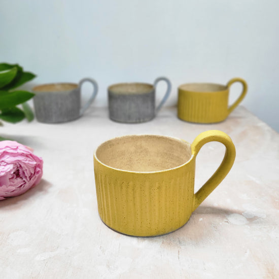 Yellow cup with handle